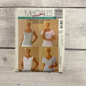 May include: A McCall's Classic Fit sewing pattern, featuring four top designs. The pattern includes instructions to learn how to fit a full bust. The package has a barcode and the number 2818.