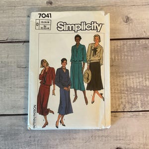 May include: A vintage Simplicity sewing pattern, number 7041, featuring illustrations of women's clothing designs. The pattern includes sizes 12-18 and European sizes 40-44. The cover displays various outfits, including dresses and separates.