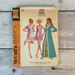 May include: A vintage McCall's 2177 sewing pattern envelope for a robe and nightgown in two lengths. The cover features illustrations of three figures wearing the garments, with text including New Easy, Two-Color Guide, and Misses' Robe and Nightgown.