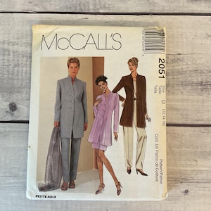 May include: A McCall's 2051 sewing pattern envelope for a long jacket, skirt, and trousers. The cover features illustrations of three outfits in gray, lavender, and brown. Text includes McCall's, 2051, Size D (12, 14, 16), and Petite-Able.