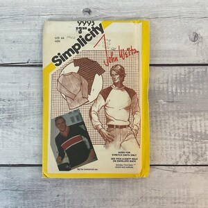 May include: A Simplicity 9993 sewing pattern envelope for a raglan sleeve shirt. The yellow and white package features illustrations of shirts, a photograph of a person wearing a striped shirt, and text including John Weitz and size 44.