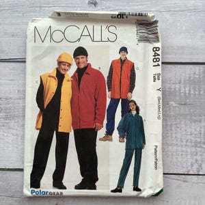 May include: McCall's Polar Gear sewing pattern featuring various jacket and vest designs. The pattern includes images of a red jacket, orange vest, and teal jacket and pants. The pattern size is Y (Sml, Med, Lrg).