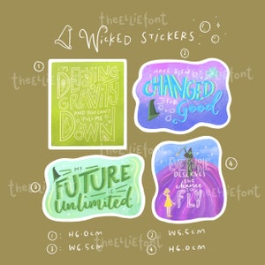 May include: Four colorful stickers with quotes from the musical "Wicked." The stickers feature phrases like "Defying Gravity" and "Everyone Deserves the Chance to Fly." Each sticker is approximately 6.0 cm high and 5.5-6.5 cm wide.