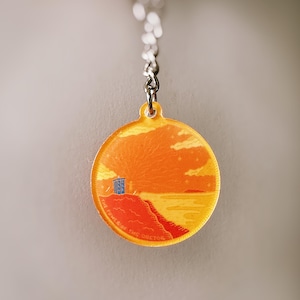 May include: A round, yellow and orange keychain with a blue TARDIS silhouette and the text "The Doctor is the TARDIS".