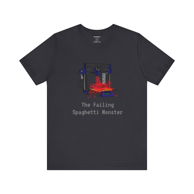 May include: A dark gray t-shirt with a graphic of a 3D printer with red filament spilling out. The text "The Failing Spaghetti Monster" is printed below the graphic.