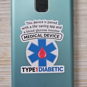 May include: A matte teal smartphone case featuring a sticker with a blue star of life symbol, a red blood drop, and text that reads: This device is paired with a life-saving app and a blood glucose monitor, MEDICAL DEVICE, and TYPE1DIABETIC.