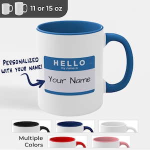 May include: White ceramic mug with a blue rim and handle. The mug has a blue name tag that says "HELLO my name is" with the text "Your Name" written in black. The mug is available in 11 or 15 ounce sizes and in multiple colors.