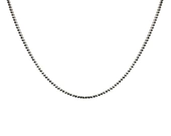 May include: A silver beaded chain necklace.