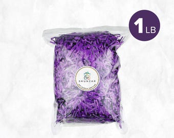 May include: A clear plastic bag filled with shredded purple paper. A purple circle with the text "1 LB" is in the upper right corner. The bag has a circular sticker with the text "SHUNZAR" and "GIFT. GLAMOUR. GRATITUDE."