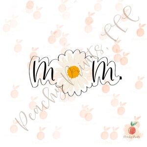 May include: A black outline of the word "mom" with a daisy flower in the center. The daisy has white petals and a yellow center. The background is white with peach-colored peach illustrations and the text "Peachy Prints".