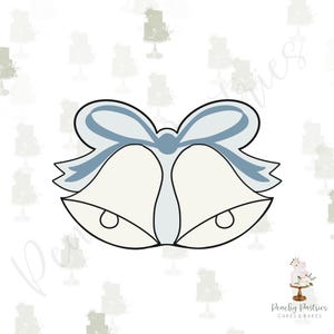 May include: A cookie cutter in the shape of two bells with a bow on top. The bells are white with a light blue bow and black outline. The background is white with a pattern of small cake illustrations.