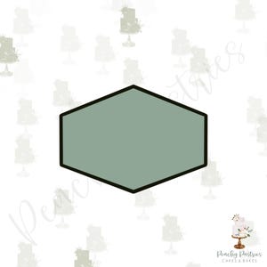 May include: A hexagonal shaped blank label with a sage green background and a black outline. The label is isolated on a white background with a pattern of faded grey cakes.