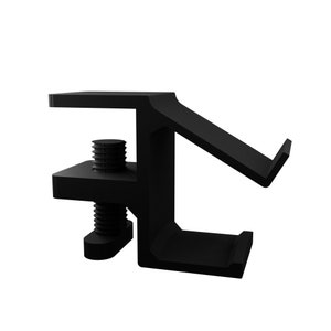 May include: Black metal bracket with two screws. The bracket has a right angle and a flat surface on one side.