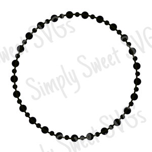 May include: A black circle made of a string of beads.