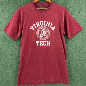 May include: A maroon t-shirt with a white graphic of the Virginia Polytechnic Institute and State University logo and the text "VIRGINIA TECH".