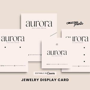 May include: A set of light pink jewelry display cards featuring the black text aurora ELEVATED PIECES. The cards include various layouts with pre-cut holes for earrings and necklaces, social media icons, and placeholders for website and business name details.