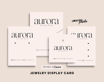May include: A set of light pink jewelry display cards featuring the black text aurora ELEVATED PIECES. The cards include various layouts with pre-cut holes for earrings and necklaces, social media icons, and placeholders for website and business name details.