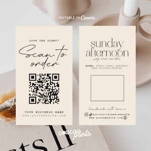 May include: Two rectangular beige business cards with black text and graphics. The left card features a QR code, the text Scan to order, and placeholders for a business name and website. The right card displays Sunday afternoon soy wax candle, scent notes, a blank square, and social media icons.
