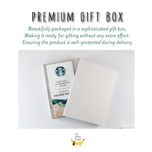 May include: White gift box with a textured lid, open to reveal a Starbucks Employee of the Month award. Text on the box reads "PREMIUM GIFT BOX". The award is in a gray felt holder. The Coco Banana Designs logo is in the bottom right.