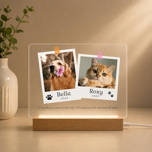 May include: A clear acrylic plaque with a wooden base featuring two polaroid-style photos of a golden dog and a ginger cat. The text reads Bella 2023, Roxy 2023, and I loved you your whole life. I'll miss you for the rest of mine.