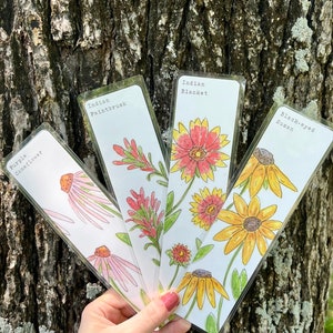 May include: Four watercolor bookmarks featuring different wildflowers. The bookmarks are labeled "Purple Coneflower", "Indian Paintbrush", "Indian Blanket", and "Black-eyed Susan".