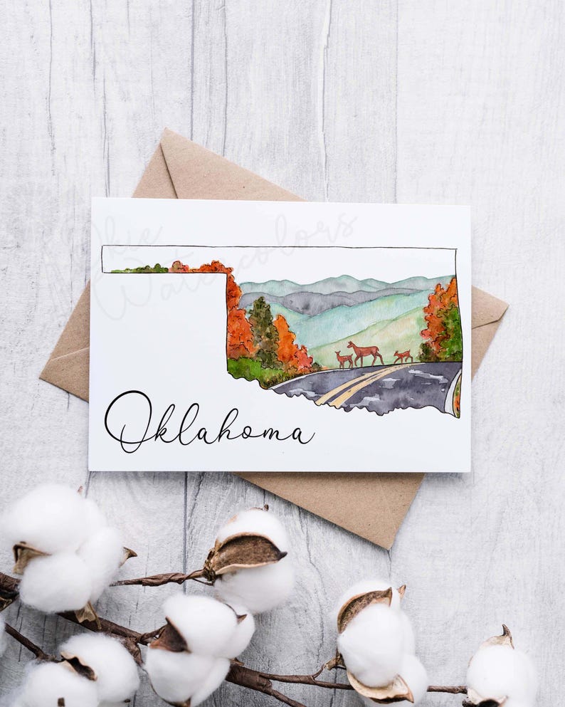 K&ouml;nnte beinhalten: Ein Aquarellbild des Bundesstaates Oklahoma mit einer Stra&szlig;e und Hirschen im Hintergrund. Der Text "Oklahoma" steht unterhalb der Staatsgrenze.