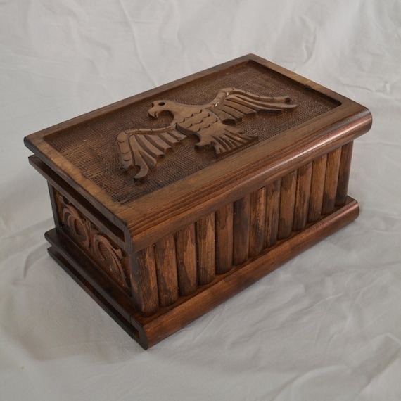 A sleek walnut puzzle box with a hand-carved secret key lock — 60 favorites make this the clear crowd favorite of the batch, and the minimalist wood craftsmanship earns it.
