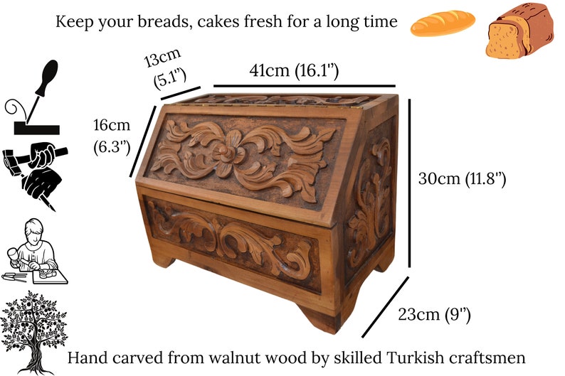 May include: A brown wooden bread box with intricate floral carvings on the front and side panels. The box measures 41 cm long, 13 cm deep, 16 cm high, and 23 cm wide. Text reads: Keep your breads, cakes fresh for a long time.