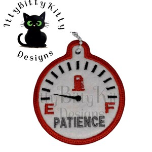 May include: A white round fuel gauge with a red border and black markings. The needle points to "E" and the gauge reads "PATIENCE".