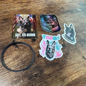 May include: A collection of items featuring German Shepherd imagery: a rectangular sticker with the text SGT. K9 QUINN, a holographic sticker with the text SGT. QUINN DO NOT PET, a sticker with the text TK9Q, a sticker with the text THEK9QUINN, and a black wristband.