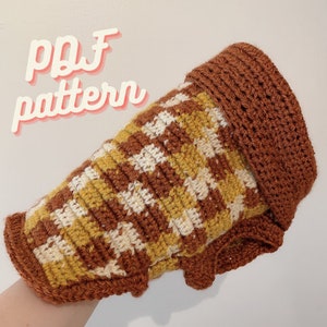 Op de afbeelding: Een bruin en crèmekleurig haakpatroon met een "pdf pattern" tekst overlay. Het haakpatroon is een gestreept ontwerp met een bruin en crème kleurenschema.