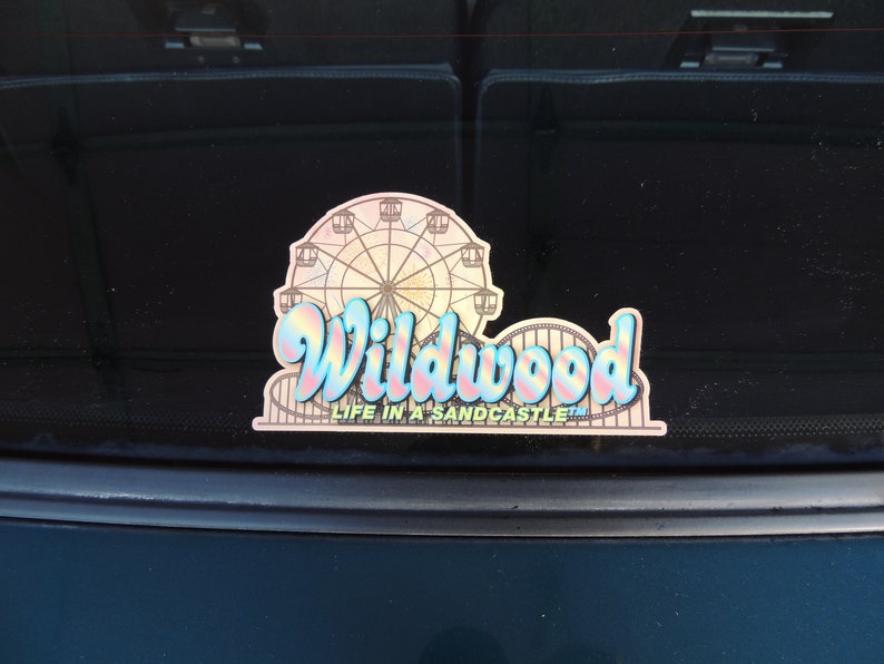 May include: A sticker featuring a colourful illustration of a Ferris wheel and the text "Wildwood Life in a Sandcastle".