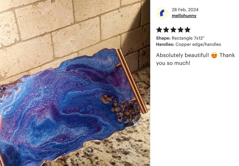 May include: A rectangular resin tray, approximately 7 x 12 inches, with a vibrant blue and purple marbled design. It features copper-colored edges and handles. The tray has a decorative appearance.