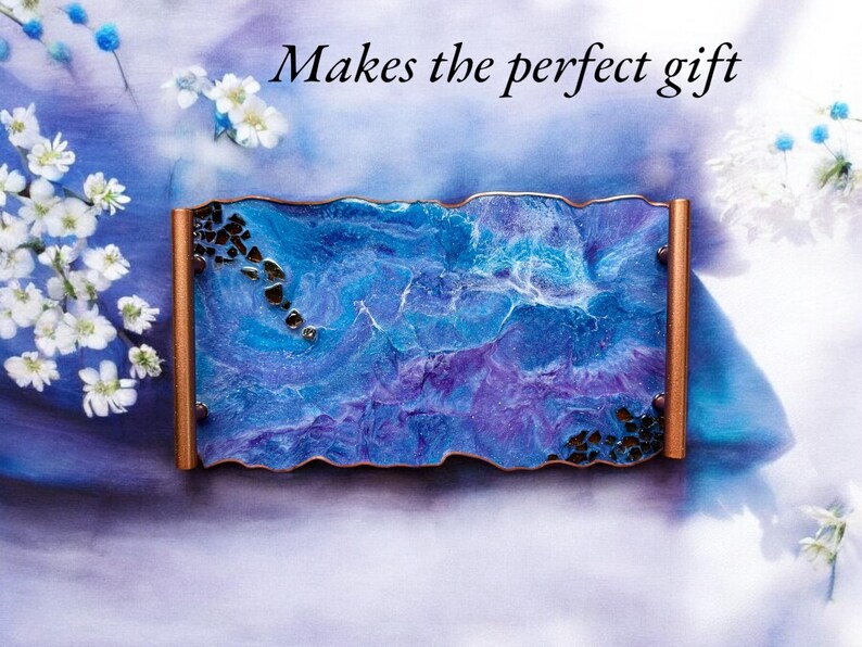 May include: A rectangular tray with a blue and purple marbled design, accented with copper-colored edges and dark embellishments. The text "Makes the perfect gift" is displayed in black script.