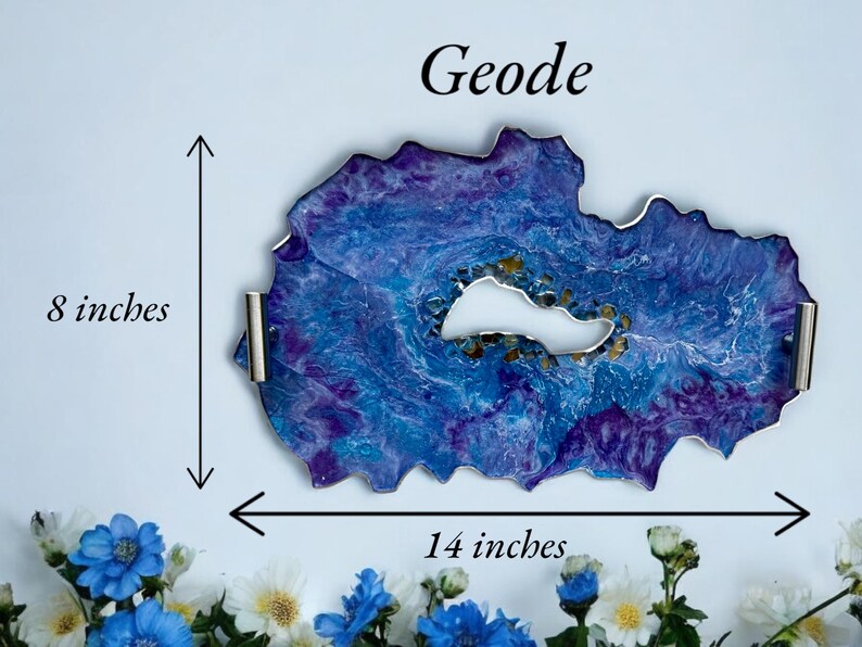 May include: A geode-shaped tray with a blue and purple marbled design, measuring 14 inches wide and 8 inches high. The tray has a white center and silver handles. The word "Geode" is written at the top.