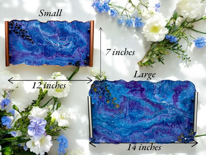 May include: Two decorative trays with a blue and purple marbled design. The small tray is 12 inches long and 7 inches wide. The large tray is 14 inches long and 7 inches wide. Both trays have copper or silver handles.