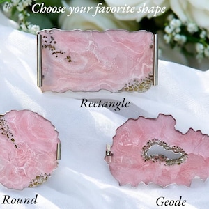 May include: Three pink agate coasters with silver metal trim. The coasters are shaped like a rectangle, a circle, and a geode. The text "Choose your favorite shape" is at the top of the image. The text "Rectangle", "Round", and "Geode" are below each coaster.