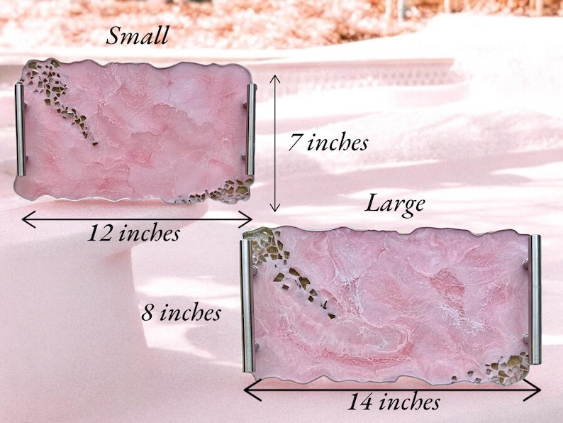 May include: Two pink resin serving trays with gold flecks. The smaller tray measures 12 inches by 7 inches. The larger tray measures 14 inches by 8 inches.