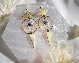 May include: Gold geometric earrings with a blue stone pendant. The earrings feature a hammered metal design and a triangle shape.