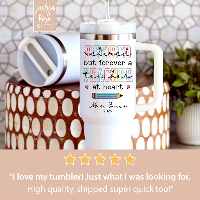 May include: White insulated tumbler with a handle and a straw. The tumbler has the text "Retired but forever a teacher at heart" with a pencil graphic. The name "Mrs. Jones" and the year "2025" are also printed on the tumbler.