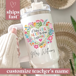 May include: White insulated tumbler with a handle, featuring a floral heart design and the text "it takes a BIG HEART to shape little MINDS". The tumbler is personalized with the name "Mrs. Williams".
