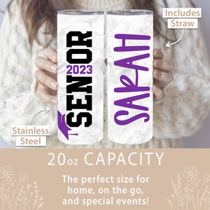 May include: Two 20 ounce stainless steel tumblers with marble-like designs. One tumbler has the text "Senior 2023" in black with a purple graduation cap. The other tumbler has the name "Sarah" in purple. Both tumblers include a straw.