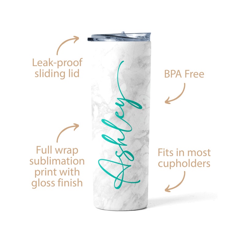 May include: White marble tumbler with a teal green inscription that reads "Ashley". The tumbler has a leak-proof sliding lid and is BPA free. It fits in most cupholders.