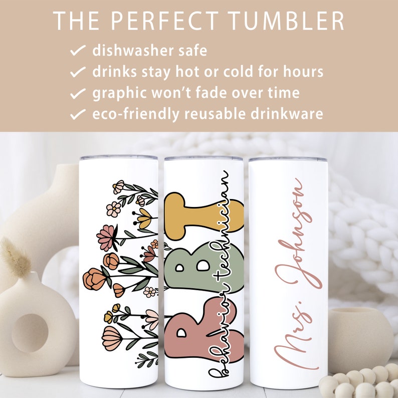 May include: Three stainless steel tumblers with different designs. The first tumbler has a floral design with pink, orange, and yellow flowers. The second tumbler has the words "behavior technician" written in green, yellow, and pink. The third tumbler has the text "Mrs. Johnson" written in pink.