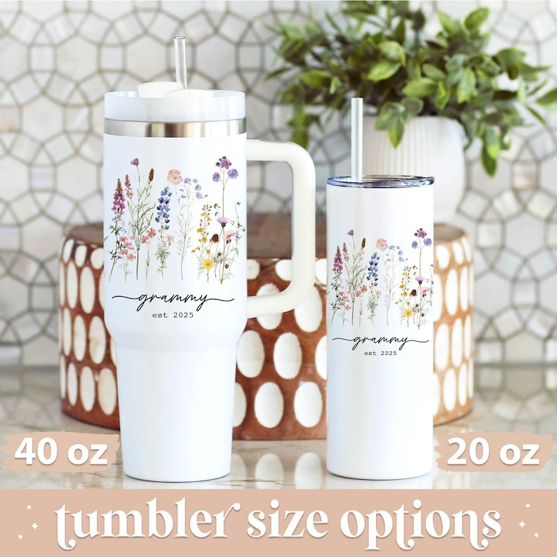 May include: White tumblers with floral designs and the word "grammy" with "est 2025". One tumbler is 40 oz with a handle, and the other is 20 oz. Both have straws. The phrase "tumbler size options" is at the bottom.