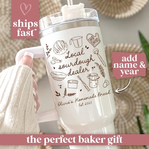 May include: White insulated tumbler with a handle, featuring a design with bread-making illustrations and the text "Local sourdough dealer." Includes the text "Olivia's Homemade Bread Est 2025."