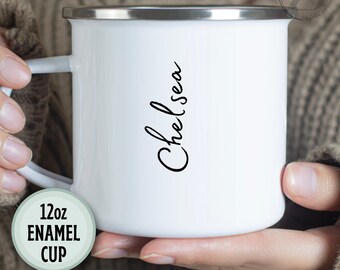 May include: White 12oz enamel cup with a silver rim and handle. The name "Chelsea" is written in black script on the side. A green circle with the text "12oz ENAMEL CUP" is in the lower left corner.