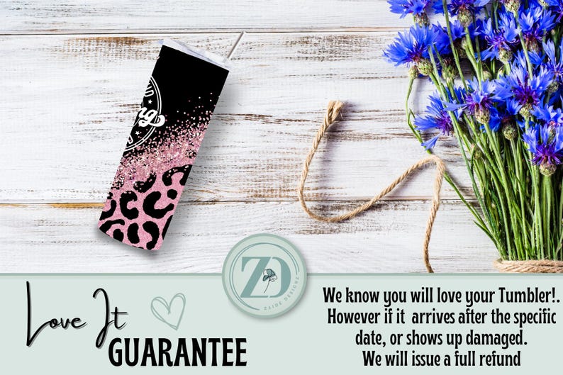 May include: A black and pink tumbler with a leopard print pattern. The tumbler has a white top and a straw. The words "Love It Guarantee" are written on the bottom left of the image.