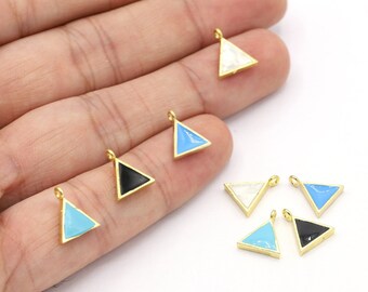 May include: Assortment of triangle-shaped charms with different colored enamel inlays. The charms are gold-toned and have a loop for attaching to jewelry.
