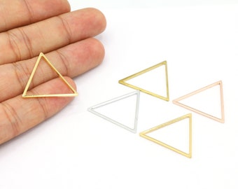 May include: Four triangle-shaped metal frames in gold, silver, and rose gold. The frames are open and can be used for jewellery making or other crafts.